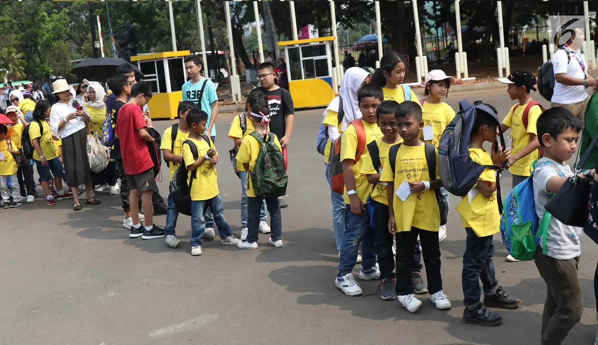 Sejumlah anak-anak bersiap mengantre masuk Istora GBK untuk menyaksikan laga Para Bulutangkis, Jakarta, Jumat (12/10). Sejumlah atlet para bulutangkis Indonesia berlaga dipartai final dan semi final. (Liputan6.com/Helmi Fithriansyah)