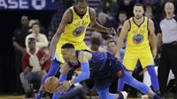 Guard Oklahoma City Thunder Russell Westbrook terjatuh saat dijaga forward Golden State Warriors Kevin Durant pada laga NBA di Oracle Arena, Sabtu (24/2/2018) atau Minggu (25/2/2018) WIB. (AP Photo/Marcio Jose Sanchez)