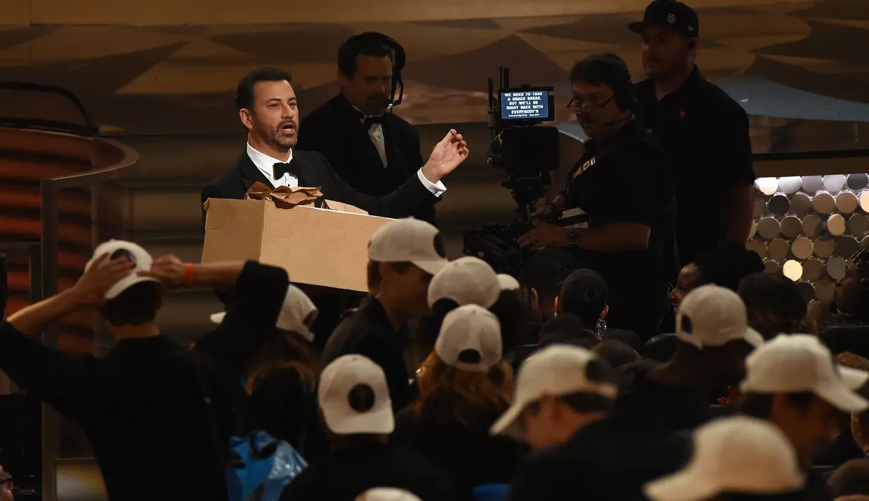 Pemandu acara Jimmy Kimmel membawa sekardus sandwich selama penghargaan Emmy Awards 2016, di Los Angeles, Minggu (18/9). Jimmy Kimmel bekerjasama dengan sang ibu membagikan 7.000 sandwich selai isi kacang kepada para hadirin. (AFP PHOTO/Valerie MACON)
