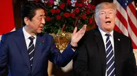 Presiden AS, Donald Trump dan PM Jepang Shinzo Abe berbincang selama pertemuan di Resor Mar-a-Lago, Florida, Selasa (17/4). Pertemuan mengangkat isu-isu lain seperti perdagangan, dan hubungan diplomatik dengan China. (AP/Pablo Martinez Monsivais)