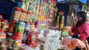 Pengunjung memilih kue kaleng di kios penjual kue kering musiman di kawasan Ciracas, Jakarta, Minggu (12/7). Sejak beberapa hari terakhir, transaksi pedagang musiman kue kering mengalami peningkatan jelang hari raya Idul Fitri. (Liputan6.com/Helmi Afandi)