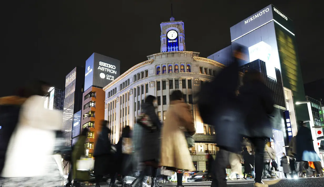 Orang-orang yang mengenakan masker untuk mengekang penyebaran virus corona COVID-19 menyeberangi jalan di kawasan Ginza, Tokyo, Jepang, Rabu (6/1/2021). Ibu kota Jepang itu mengkonfirmasi lebih dari 1.500 kasus baru virus corona COVID-19 pada 6 Januari 2021. (AP Photo/Eugene Hoshiko)