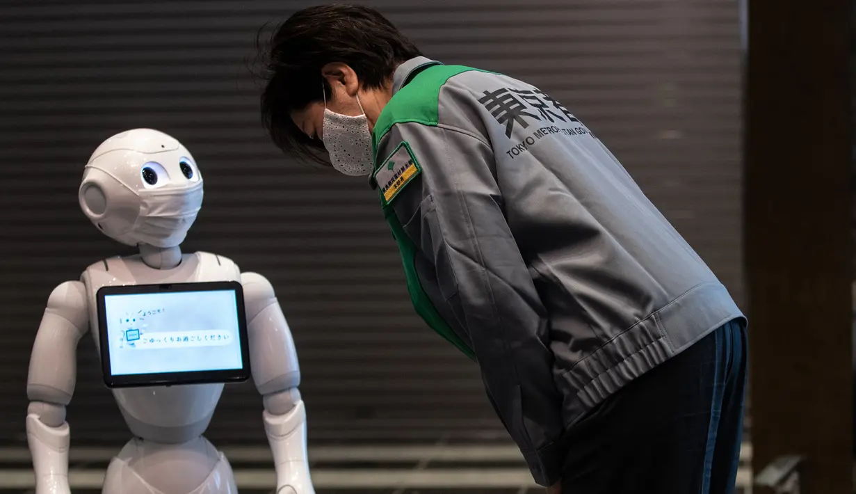 Gubernur Tokyo Yuriko Koike (kanan) melihat robot Pepper saat mengunjungi hotel yang diubah menjadi lokasi karantina pasien COVID-19 di Tokyo, Jepang, Jumat (1/5/2020). Sejumlah hotel di Tokyo mengerahkan robot untuk menyambut pasien COVID-19 dengan gejala ringan. (Philip FONG/AFP)