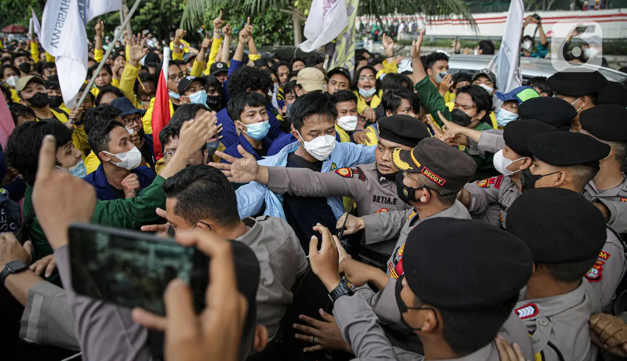 Mahasiswa yang tergabung dalam Aliansi BEM Seluruh Indonesia (BEM SI) saling dorong dengan polisi saat menggelar aksi di sekitar Gedung Merah Putih KPK, Jakarta, Senin (27/9/2021). Polisi menahan mahasiswa untuk merangsek maju. (Liputan6.com/Faizal Fanani)