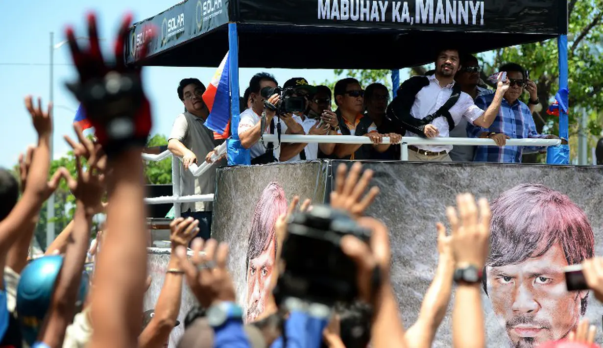 Manny Pacquiao tetap disambut sebagai pahlawan oleh rakyat Filipina. (AFP PHOTO/NOEL CELIS)