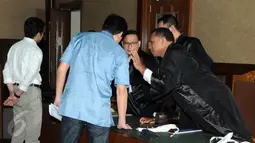 Presdir Agung Podomoro Land. yang menjadi tersangka kasus suap Raperda reklamasi Teluk Jakarta, Ariesman Widjaja berdiskusi dengan kuasa hukumnya saat sidang perdana di Pengadilan Tipikor, Jakarta, Kamis (23/6). (Liputan6.com/Helmi Afandi)