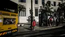 Seorang wanita menunggu untuk menyeberang jalan dekat halte bus di Cais do Sodre di Lisbon (14/7/2021). Pemerintah berusaha untuk mengendalikan kebangkitan infeksi virus corona, karena varian Delta yang lebih menular. (AFP/Patricia De Melo Moreira)