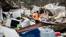 Seorang ibu bersama anaknya menyusuri peternakan yang rusak akibat badai besar di Negara Bagian Georgia, Amerika Serikat, Minggu (22/1). Gubernur Nathal Deal mengatakan ada tujuh distrik di selatan Georgia yang dinyatakan darurat. (AP Photo/Branden Camp)