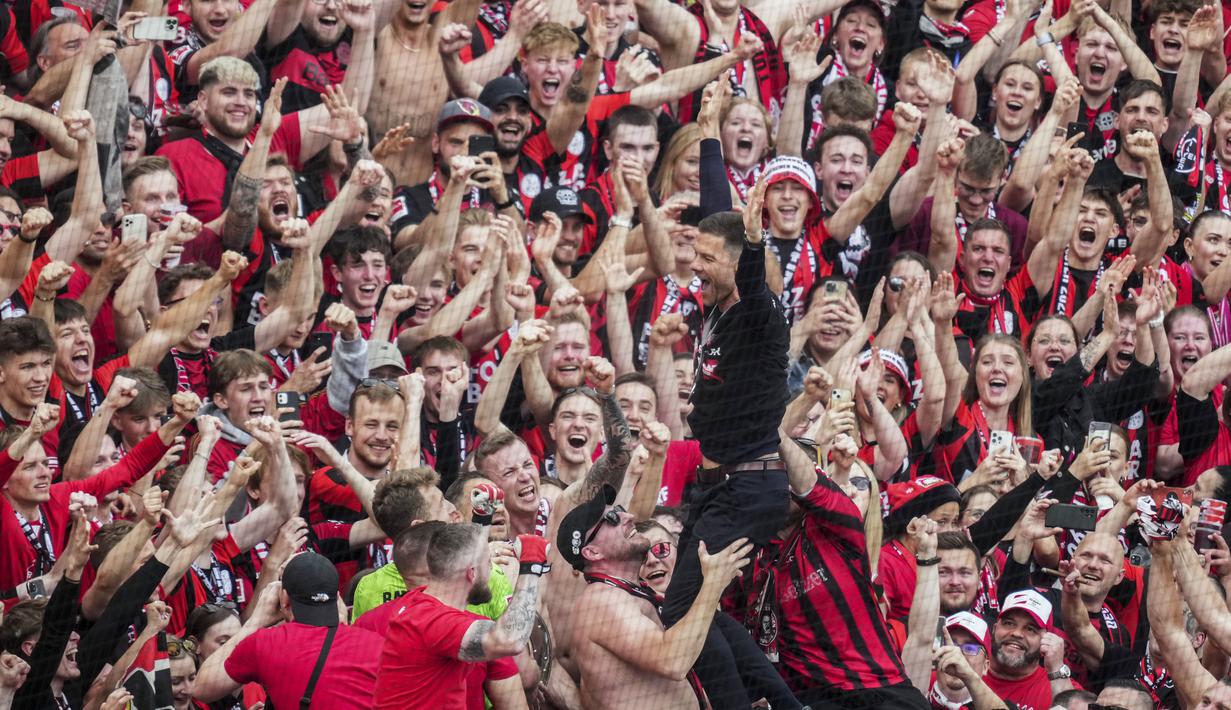 Pelatih Bayer Leverkusen, Xabi Alonso, merayakan gelar juara Bundesliga 2024 bersama suporter di BayArena, Sabtu (18/5/2024). (AP Photo/Michael Probst)