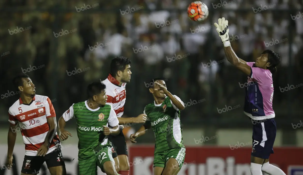 Kiper Madura United, Erry Prasetyo (kanan), mengamankan bola serangan PS TNI dalam laga Torabika Soccer Championship presented by IM3 Ooredoo di Stadion Siliwangi, Bandung, Minggu (1/5/2016). (Bola.com/Vitalis Yogi Trisna)