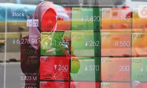 Pejalan kaki melintas dekat layar pergerakan Indeks Harga Saham Gabungan (IHSG) di kawasan Jakarta, Senin (13/1/2020). IHSG menguat 0,34 persen atau 21 poin ke level 6.296 pada penutupan perdagangan Senin (13/1) sore ini. (Liputan6.com/Angga Yuniar)