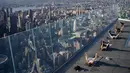 Praktisi yoga menghadiri kelas di Edge Observation Deck, Manhattan, New York, Amerika Serikat, Kamis (17/6/2021). Edge Observation Deck disebut sebagai 'dek langit luar ruang tertinggi di Belahan Barat'. (Ed JONES/AFP)