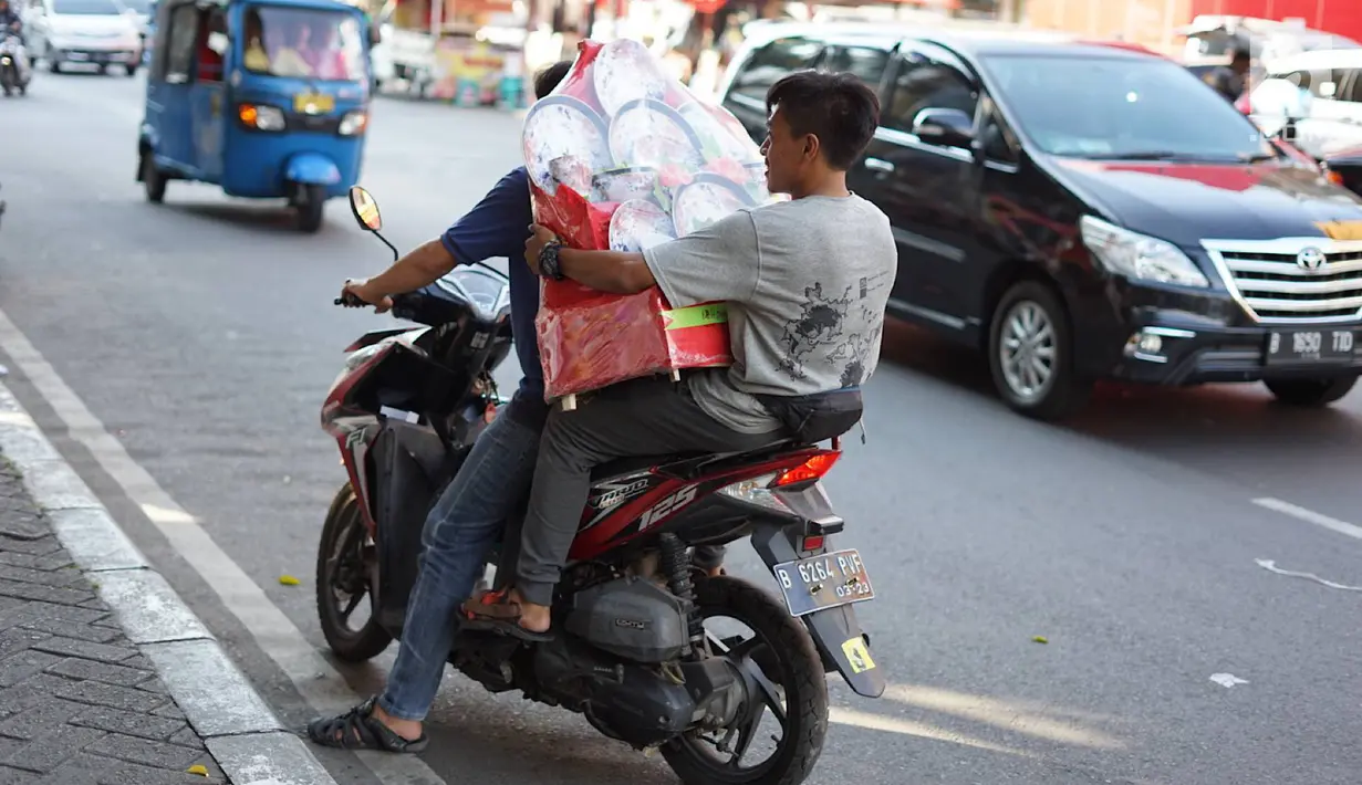 Pembeli usai membeli parsel di kawasan Cikini, Jakarta, Selasa (28/5/2019). Penjualan parsel di kawasan ini menurun disebabkan turunnya permintaan, salah satunya akibat larangan menerima bingkisan bagi pejabat dan PNS di Indonesia oleh KPK. (Liputan6.com/Immanuel Antonius)