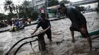 Petugas menggunakan pompa penyedot banjir dari Pemprov DKI untuk menguras genangan banjir di depan Ancol, Jakarta, Kamis (21/4). Hujan deras yang mengguyur sejak semalam menyebabkan beberapa kawasan di Jakarta tergenang banjir (Liputan6.com/Faizal Fanani)