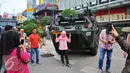 Seorang perempuan berselfie di depan panser Anoa milik TNI di LTC Glodok, Jakarta, Jumat (4/11). Anoa itu diparkir di depan LTC Glodok untuk mengantisipasi jika terjadi kerusuhan di pusat perbelanjaan tersebut. (Liputan6.com/Angga Yuniar)