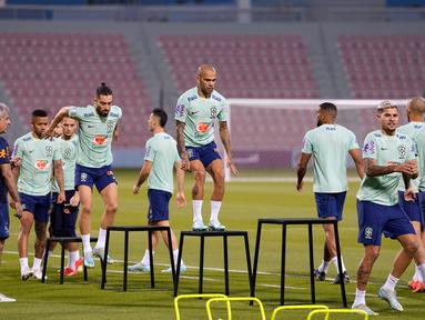 Pemain Brasil Dani Alves (tengah) dan rekan satu timnya berolahraga saat sesi latihan di Stadion Grand Hamad, Doha, Qatar, 29 November 2022. Brasil akan menghadapi Kamerun dalam pertandingan sepak bola Grup G Piala Dunia 2022 pada 2 Desember. (AP Photo/Andre Penner)