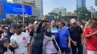 Pasangan bakal calon gubernur dan bakal calon wakil gubernur Jakarta, Pramono Anung-Rano Karno menyambangi kawasan car free day di Bundaran Hotel Indonesia (HI) Jakarta, Minggu (1/9/2024). (Liputan6.com/Muhammad Radityo Priyasmoro)