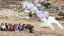 Pengunjuk rasa Palestina melaksanakan salat di tengah tembakan gas air mata oleh tentara Israel di dekat desa Beit Dajan, timur Nablus, Palestina (9/10/2020). (AFP/Jaafar Ashtiyeh)