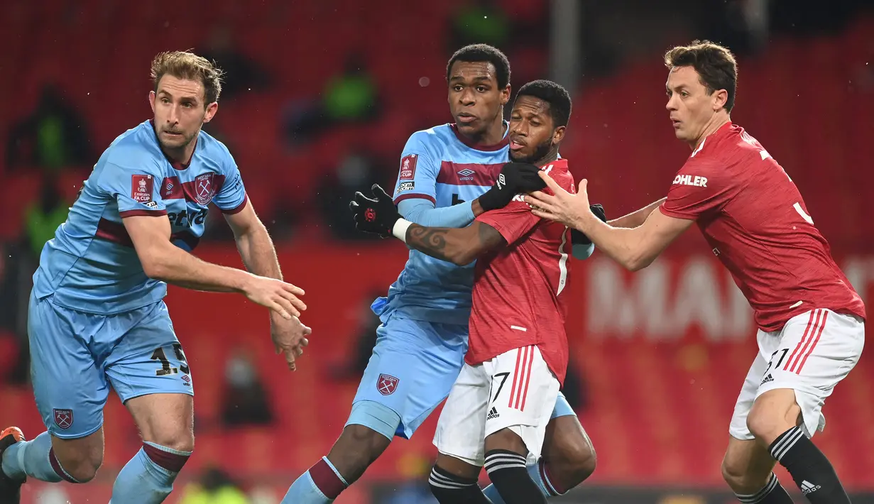 Bek West Ham United, Issa Diop (kedua dari kiri) menghalangi gelandang Manchester United, Fred saat terjadi tendangan sudut dalam laga babak kelima Piala FA 2020/21 di Old Trafford Stadium, Selasa (9/2/2021). West Ham kalah 0-1 (0-0) melalui extra time. (AFP/Michael Regan/Pool)