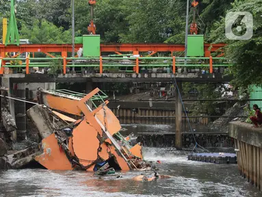 Warga melihat pos pantau Pintu Air yang rubuh di wilayah Palmerah, Jakarta, Selasa (6/2/2024). (Liputan6.com/Herman Zakharia)