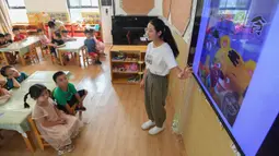 Seorang guru bercerita sebelum waktu makan di sebuah taman kanak-kanak di Changsha, Provinsi Hunan, China, 2 September 2020. Taman kanak-kanak tersebut menumbuhkan kesadaran anak-anak untuk menghargai makanan sejak usia dini dan membantu mereka membentuk kebiasaan makan yang baik (Xinhua/Chen Zeguo)