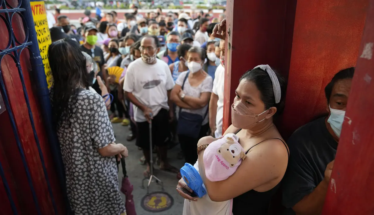 <p>Seorang perempuan bersama bayinya menunggu tempat pemungutan suara (TPS) dibuka untuk menggunakan hak pilihnya pada Pemilu Filipina di Quezon City, Senin (9/5/2022). Warga Filipina mulai memberikan suara untuk memilih presiden baru pada hari Senin, dengan putra mantan diktator yang digulingkan menjadi pesaing terkuat seorang pejuang reformasi dan hak asasi manusia. (AP Photo/Aaron Favila)</p>