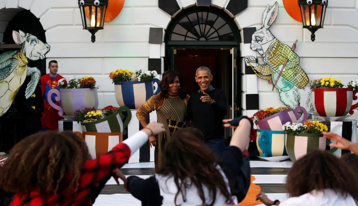 Reaksi Presiden AS, Barack Obama dan ibu negara Michelle Obama menyaksikan tarian flash mob dari anak-anak yang berdandan ala zombie saat merayakan Halloween di Gedung Putih, Washington, Senin (31/10). (REUTERS / Jonathan Ernst)
