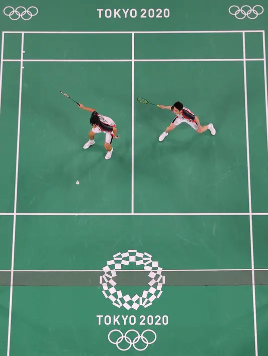 Ganda putra Indonesia Kevin Sanjaya/Marcus Gideon saat melawan pasangan India Chirag Shetty/Satwiksairaj Rankireddy pada cabang bulu tangkis Olimpiade Tokyo 2020 di Musashino Forest Sports Plaza, Tokyo, Senin (26/7/2021). Kevin/Marcus menang 21-13 dan 21-12. (AFP/Pool/Lintao Zhang)