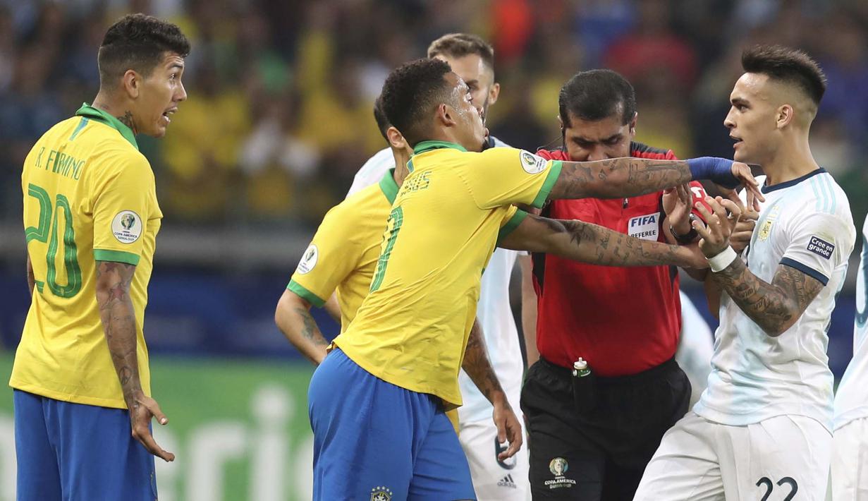 Striker Brasil, Roberto Firmino, bersitegang dengan striker Argentina, Lautaro Martinez, pada laga Copa America 2019 di Stadion Mineirao, Rabu (3/7). Brasil menang 2-0 atas Argentina. (AP//Natacha Pisarenko)
