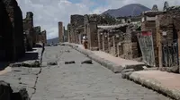 Seorang perempuan mengunjungi situs arkeologi Pompeii seusai kebijakan lockdown selama dua bulan untuk mengendalikan penyebaran Covid-19 di Italia, Selasa (26/5/2020). Salah satu situs arkeologi paling terkenal di dunia ini dibuka kembali untuk umum pada 26 Mei. (AP Photo/Alessandra Tarantino)