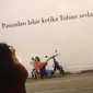 Seorang anak kecil berpose di depan mural bertema Kota Bandung di Jalan Asia Afrika, Bandung, Jawa Barat, Selasa (5/7). Dua buah mural tersebut menjadi lokasi favorit bagi warga dan wisatawan di Bandung untuk berfoto. (Liputan6.com/Immanuel Antonius)
