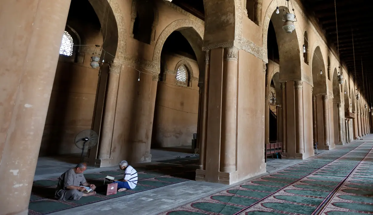 Dua orang pria memanfaatkan bulan suci Ramadan dengan membaca Al Quran di Masjid Ibnu Tulun, Kairo, 2 Juni 2017. Masjid yang dibangun pada 876-879 di masa pemerintahan Ahmad Ibn Tulun ini merupakan masjid tertua kedua di Mesir (REUTERS/Amr Abdallah Dalsh)