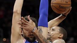 Aksi pemain Cleveland Cavaliers, George Hill (kanan) melakukan dunk saat diadang pemain Philadelphia 76ers, Marco Belinelli #18 pada laga NBA basketball game di Quicken Loans Arena, Cleveland,  (1/2/2018).  Cavs kalah 97-108. (AP /Tony Dejak)