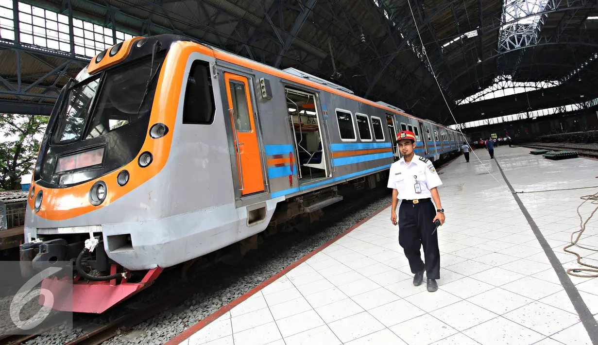 Petugas PT KAI berjalan disamping KRL saat dilakukan uji coba jalur di Stasiun Tanjung Priok, Jakarta, Senin (23/11). Stasiun seluas 3.768 meter persegi tersebut rencananya akan digunakan setelah renovasi Januari 2016. (Liputan6.com/Immanuel Antonius)