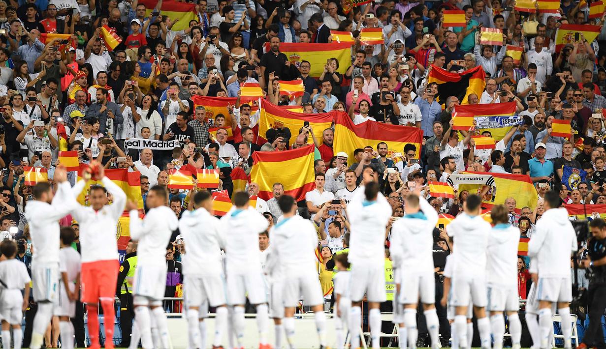 Para suporter Real Madrid membentangkan bendera Spanyol saat pertandingan melawan Espanyol di La Liga di stadion Santiago Bernabeu, Spanyol (1/10). Aksi ini untuk memperlihatkan respons terkait referendum di Catalonia. (AFP Photo/Gabriel Bouys)