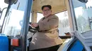 Kim Jong-un saat mengendarai traktor di Kumsong Tractor Factory dalam foto tak bertanggal yang dirilis kantor berita KCNA, (15/11). Traktor buatan dalam negeri ini wujud kemandirian Korut di tengah sanksi internasional. (AFP Photo/Kcna Via Kns/Str)