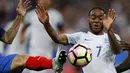 Pemain Prancis, Lucas Digne (kiri) menghalau bola dari kejaran pemain Inggris, Raheem Sterling pada laga persahabatan di Stade de France, Saint Denis, Paris, (13/6/2017).  Prancis menang 3-2. (AP/Francois Mori)