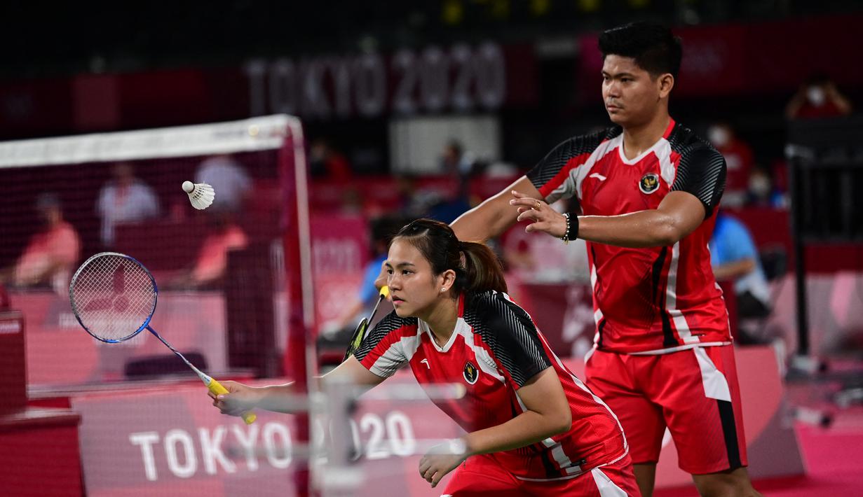 Ganda campuran Indonesia Melati Daeva Oktavianti dan Praveen Jordan saat melawan Simon Leung dan Gronya Somerville dari Australia pada Grup C cabang bulu tangkis Olimpiade Tokyo 2020 di Musashino Forest Sports Plaza, Sabtu (24/7/2021). Praveen / Melati menang 20-22, 21-17 dan 21-13 (Pedro PARDO/AFP)