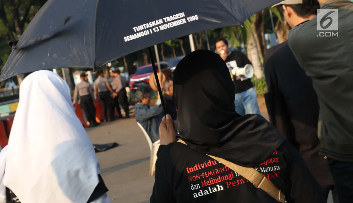 Aktivis yang tergabung dalam Jaringan Solidaritas Korban untuk Keadilan saat aksi Kamisan di depan Istana Negara, Jakarta, Kamis (25/7/2019). Aksi Kamisan ke-594 mengangkat tema '23 Tahun Tragedi 27 Juli Saat Jadi Penguasa Kok Malah Tidak Peduli?'. (Liputan6.com/Helmi Fithriansyah)