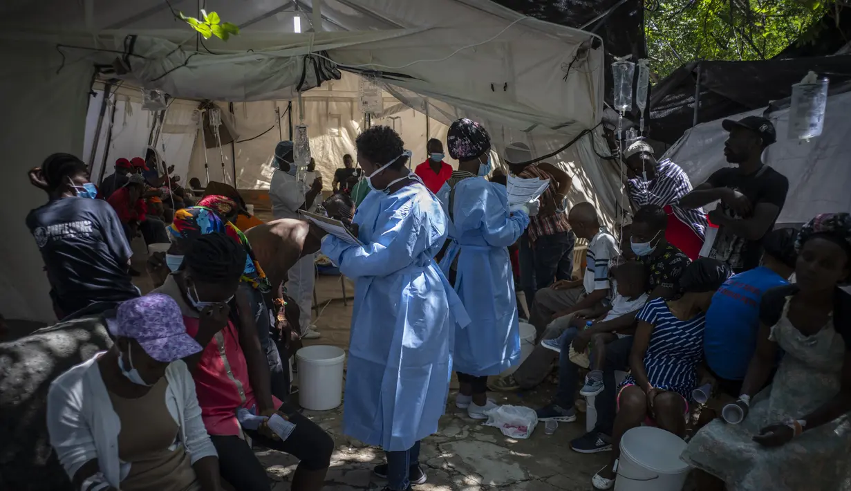 Tenaga medis merawat pasien dengan gejala kolera di sebuah klinik yang dikelola oleh Doctors Without Borders di Port-au-Prince, Haiti, Kamis, 27 Oktober 2022. Untuk pertama kalinya dalam tiga tahun, orang-orang di Haiti telah sekarat karena kolera, meningkatkan kekhawatiran tentang skenario yang berpotensi menyebar cepat dan menghidupkan kembali ingatan tentang epidemi yang menewaskan hampir 10.000 orang satu dekade lalu. (AP/Ramon Espinosa)