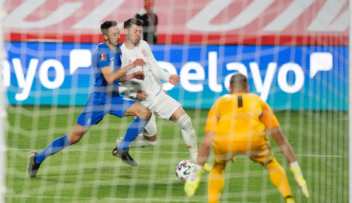 Penyerang Timnas Yunani, Georgios Giakoumakis (Kiri) menantang pemain depan Spanyol, Alvaro Morata pada kualifikasi Piala Dunia 2022 zona Eropa Grup B di stadion Los Carmenes , Granada, Jumat (26/3/2021) dinihari WIB. Spanyol tertahan 1-1 saat menjamu Yunani. (JORGE GUERRERO/AFP)