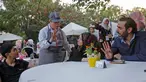 Seorang anak down syndrome Abdel Rahman melayani pelanggan di kedai kopi Sucet  selama festival "Sham gather us" di Damascus (11/7). Enam belas anak laki-laki dan perempuan down syndrome bekerja di Cafe Sucet melayani pelanggan. (AFP Photo/Louai Beshara)