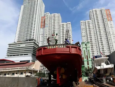 Pekerja memperbaiki kapal nelayan yang rusak di kawasan Muara Angke, Jakarta Utara, Selasa (7/11). Perbaikan ini rutin dilakukan untuk memperkokoh bagian-bagian kapal agar bisa maksimal saat berlayar untuk mencari ikan di laut. (Liputan6.com/Johan Tallo)