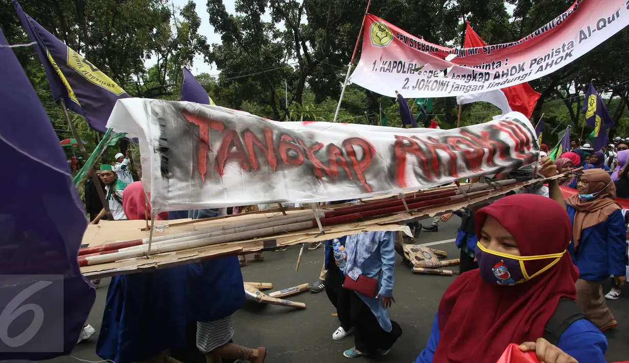 Massa aksi membawa keranda saat melintas di Jalan Medan Merdeka Selatan, Jakarta, Jumat (4/11). Dalam aksinya, massa menuntut agar polisi segera menangkap Gubernur Nonaktif Basuki T Purnama atas dugaan penistaan agama. (Liputan6.com/Immanuel Antonius)