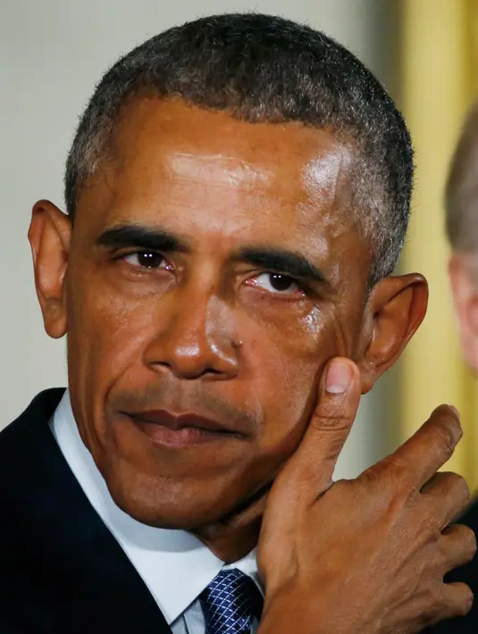 Sambil menyeka air mata, Presiden AS Barack Obama memaparkan langkah yang akan diambil pemerintahannya untuk mengurangi kekerasan senjata di Gedung Putih, Selasa (5/1). (REUTERS/ Carlos Barria)