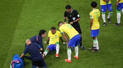 Pemain Brasil, Neymar Jr mendapat perawatan tim medis dalam pertandingan Grup G Piala Dunia 2022 melawan Serbia, Jumat (25/11/2022) dini hari WIB. (AP Photo/Darko Vojinovic)