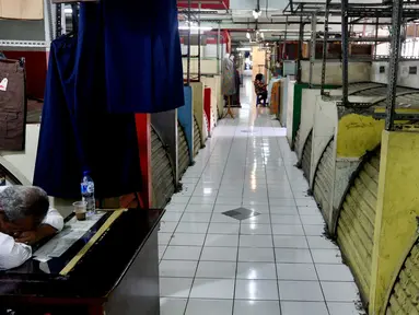 Seorang pedagang tertidur di depan kiosnya yang berada di Blok G Pasar Tanah Abang, Jakarta, Rabu (7/3). Wakil Gubernur DKI Jakarta Sandiaga Salahuddin Uno mengatakan, akan segera merobohkan Blok G Pasar Tanah Abang. (Liputan6.com/Johan Tallo)