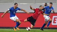 Gelandang Albania, Eros Grezda, terjatuh saat berusaha melewati bek Italia, Leonardo Bonucci, pada laga kualifikasi Piala Dunia 2018 di Stadion Loro Borici, Senin (9/20/2017). Italia menang 1-0 atas Albania. (AFP/Dimitar Dilkoff)