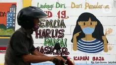 Warga melintas di depan mural yang berisi pesan 3M di Jakarta, Rabu (11/11/2020). Mural tersebut dibuat untuk mengingatkan masyarakat agar menerapkan protokol kesehatan saat beraktivitas sehari-hari. (Liputan6.com/Herman Zakharia)