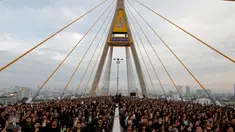 Ribuan warga hadir mengenakan baju hitam-hitam saat acara HUT terakhir almarhum Raja Thailand, Bhumibol Adulyadej di atas Jembatan Bhumibol, Bangkok, Thailand, Senin (5/12). Raja Bhumibol meninggal di usia 88 tahun. (REUTERS/Jorge Silva)